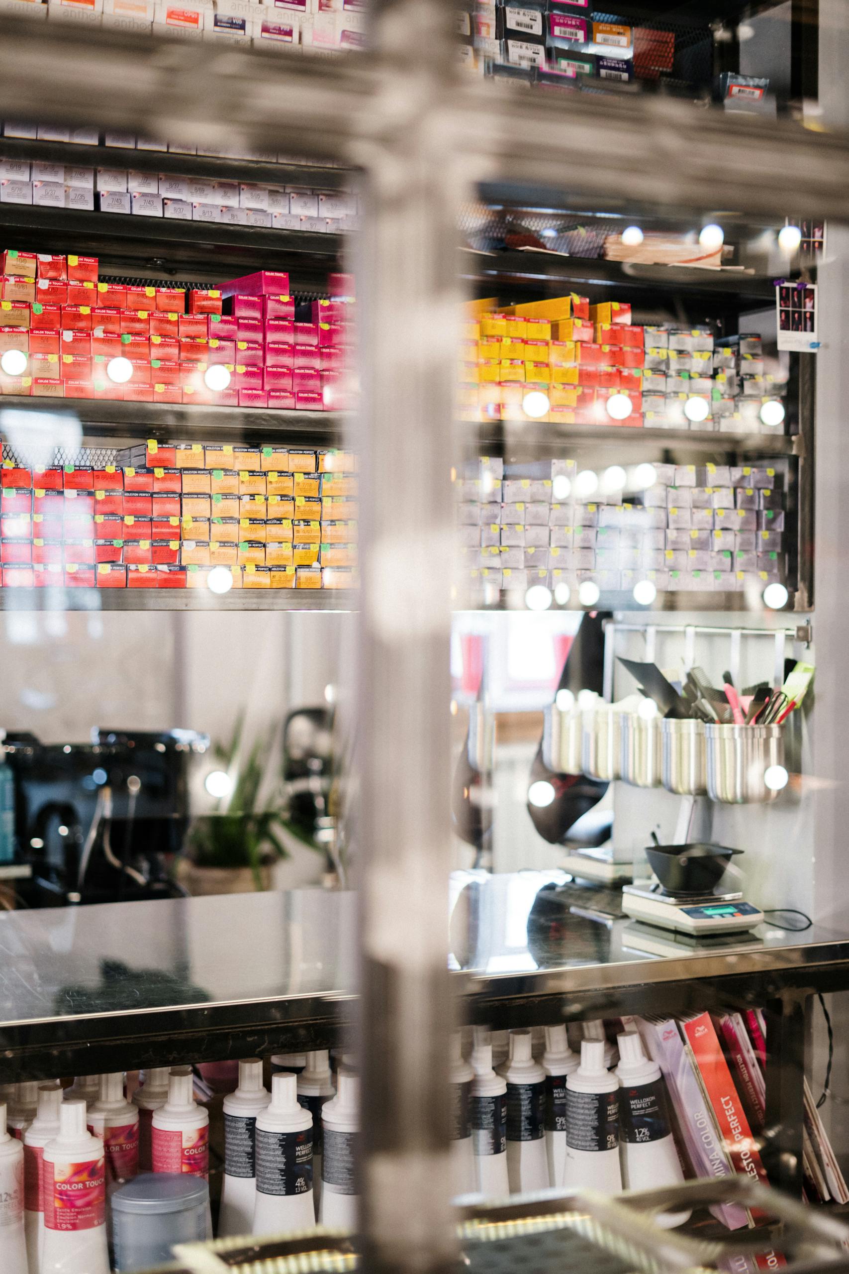 A vibrant Shihuanuo hair salon showcasing neatly organized hair coloring products and tools.