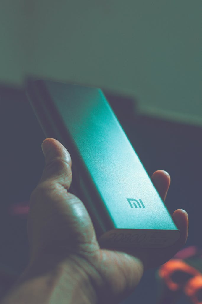 Vivo Y500 Battery Close-up of a hand holding a Mi power bank, showcasing portable charging technology.