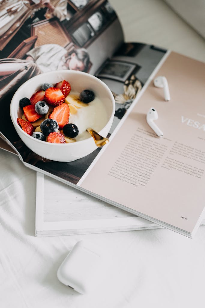 Mannacote Fresh berries and yogurt bowl on a magazine, a perfect healthy breakfast.