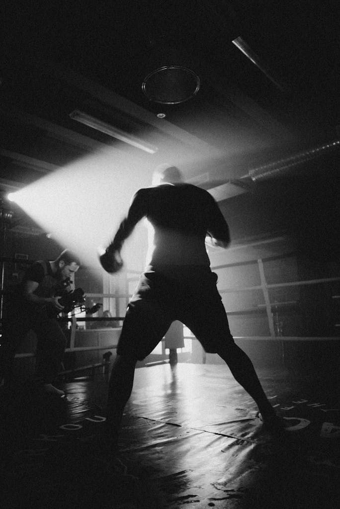 Panantukan DVDs Monochrome silhouette of a boxer during training shoot, captured with dramatic lighting.
