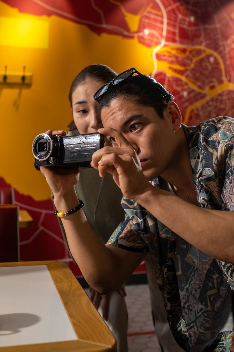 Mike Wolfe Passion Project Two filmmakers capturing a scene indoors, focused on creativity and teamwork.
