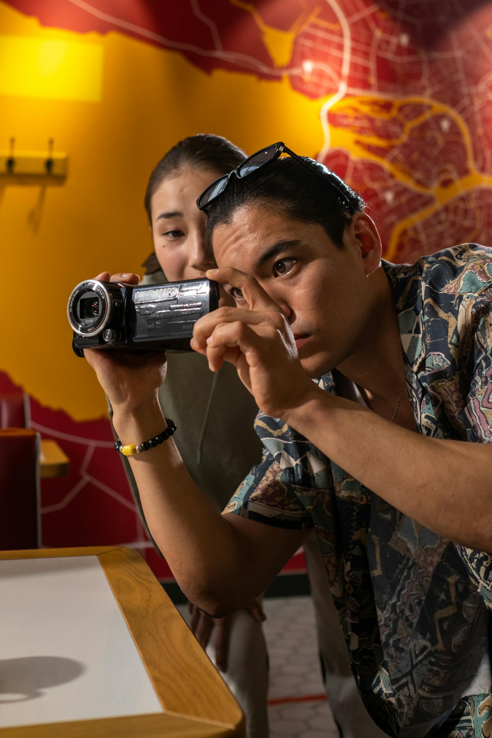 Mike Wolfe Passion Project Two filmmakers capturing a scene indoors, focused on creativity and teamwork.