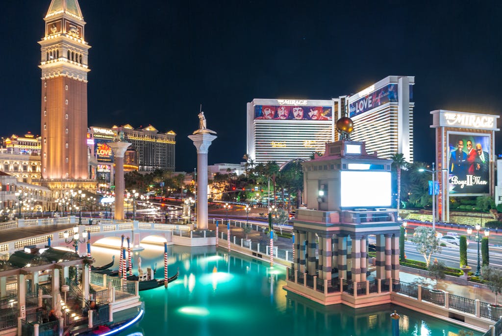 56dbet A stunning night view of Las Vegas Strip featuring illuminated landmarks and vibrant reflections.