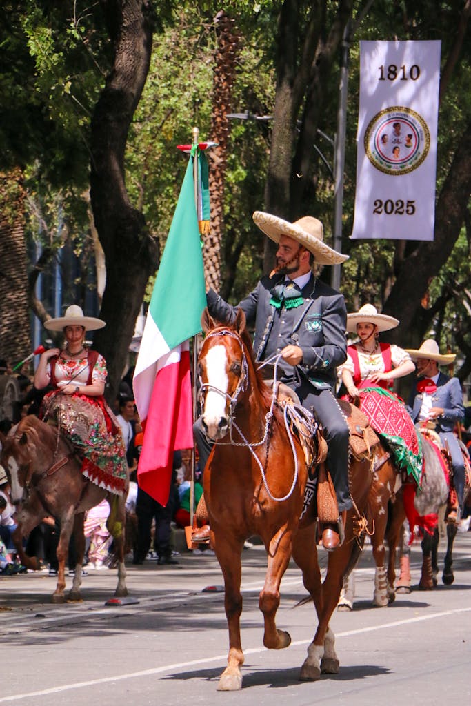 5 Movierulz 2025 Charros on horseback with Mexican flag in a parade celebrating tradition and culture.