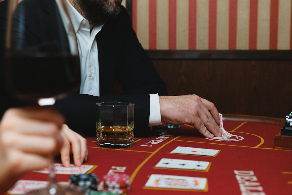 Elegant 277bet.com scene with playing cards, poker chips, and beverages on a table.