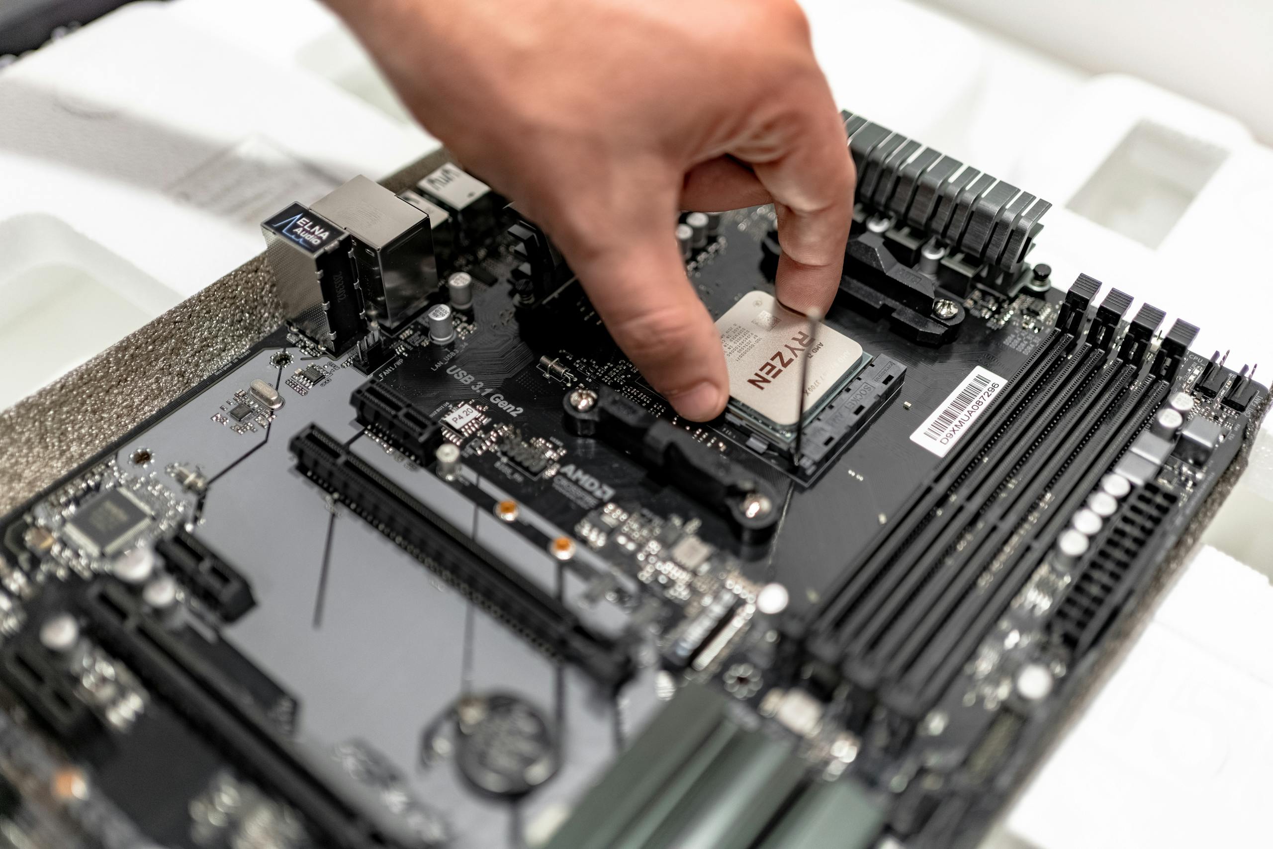 Link Slot gcslot.org Person's hand installing a CPU on a motherboard, showcasing PC maintenance and repair.