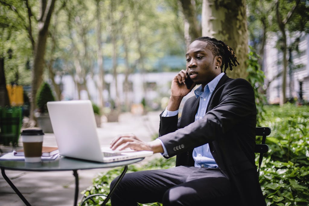 Kirstentoosweet Leaked Serious stylish young African American male manager in formal wear browsing laptop while having phone call in outdoor cafe