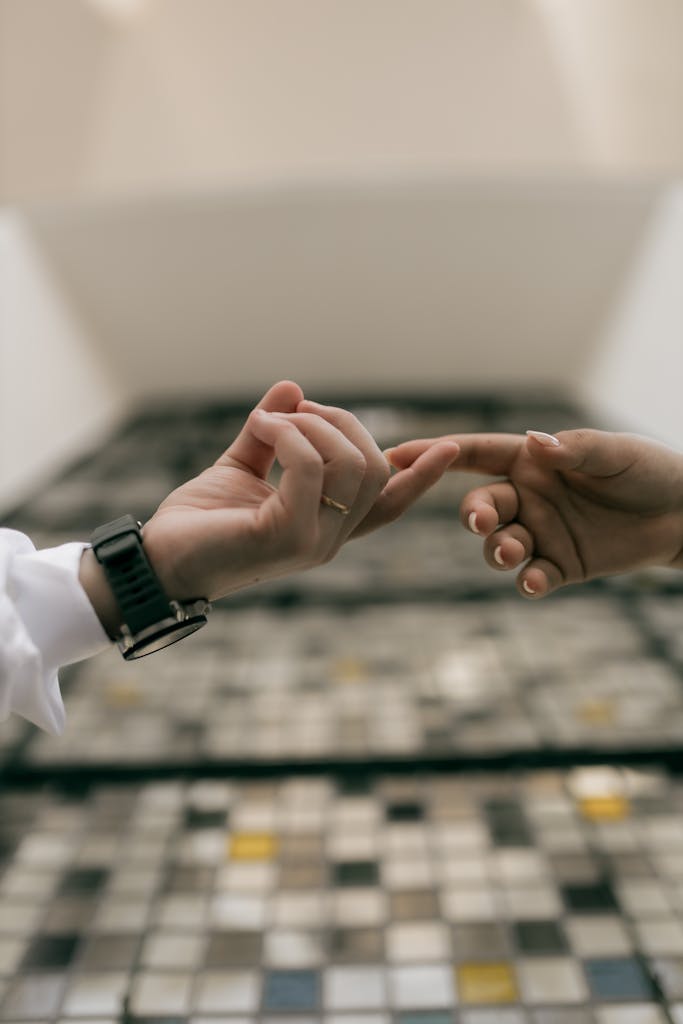 Two hands reaching towards each other, symbolizing connection and unity.