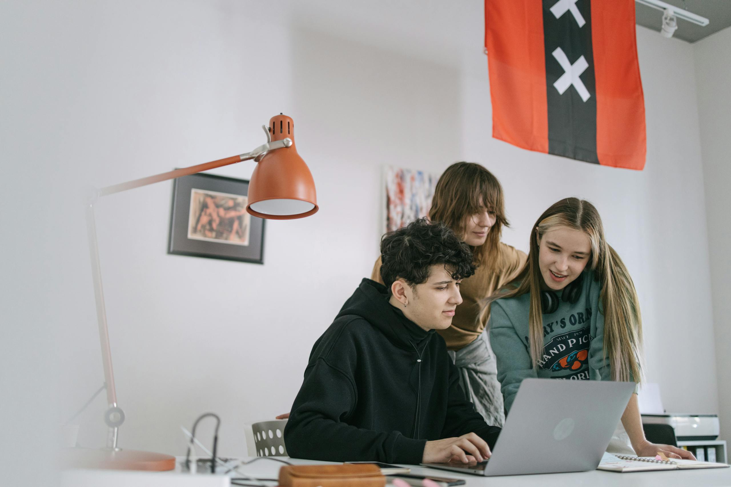 Dev to Baddies A diverse group of young adults collaborating on a project in a modern office setting.