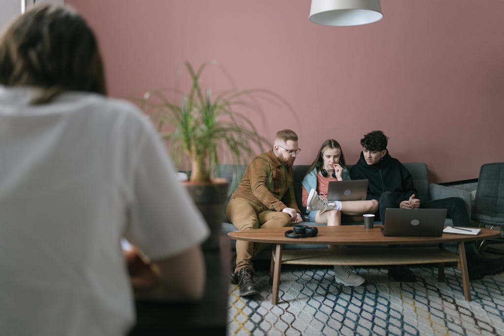 Dev to Baddies A diverse group of young professionals collaborating on a project in a contemporary office setting.