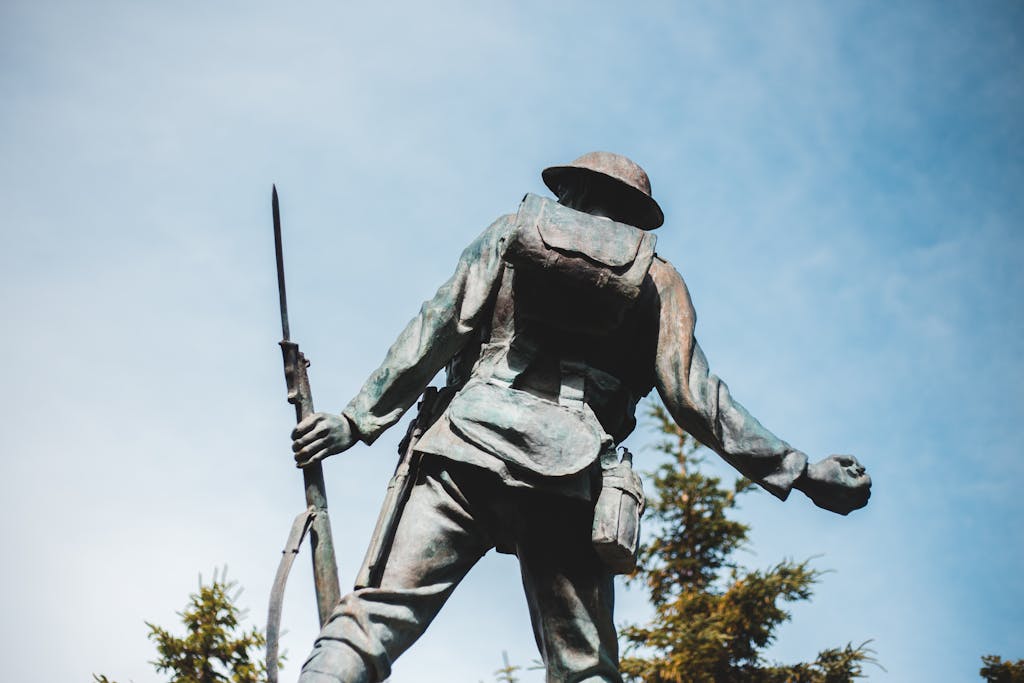 World War 1 World War 1Bronze sculpture of World War I soldier holding a rifle, with blue sky backdrop.