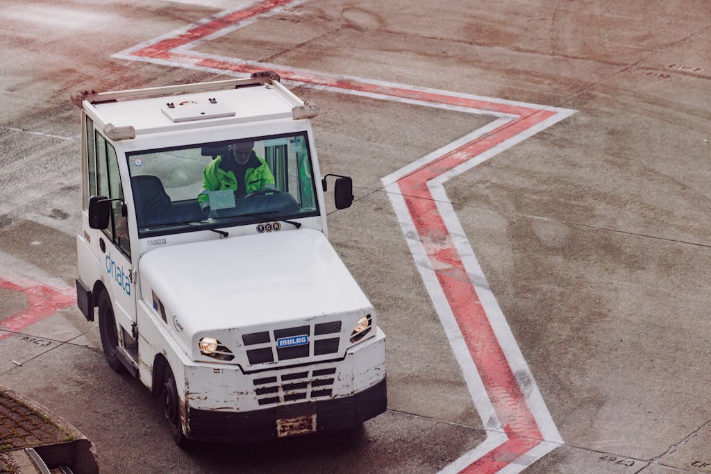 vRealize Infrastructure Navigator A ground crew vehicle navigates the airport tarmac during daytime operations.