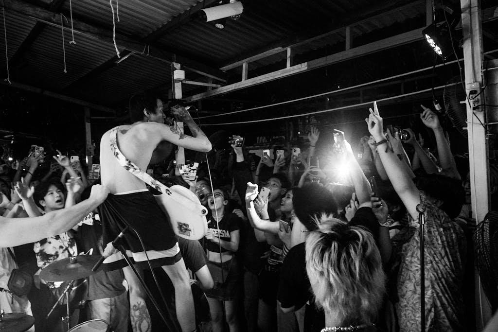 Wynonna Judd Performance Reactions Energetic live music concert with crowd engagement and artist performance in black and white.