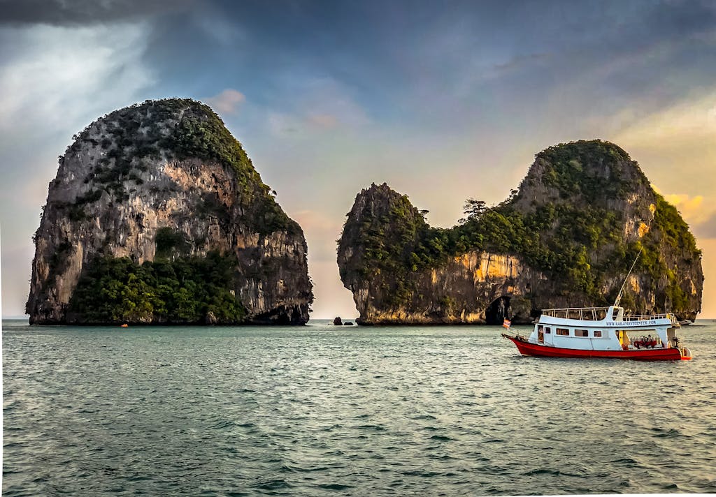 Pak vs Ind Explore the stunning limestone islands off the coast of Krabi, Thailand, with a vibrant boat.