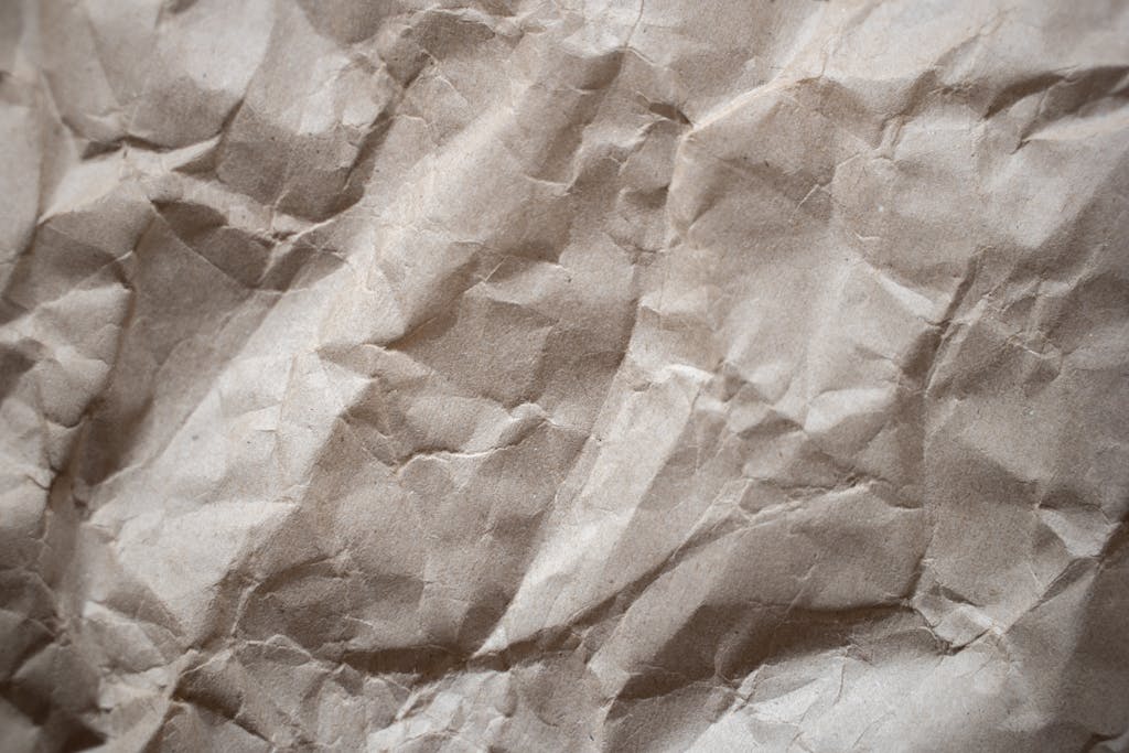 redeepseek Textured background of crumpled thick paper surface of light brown color in daylight